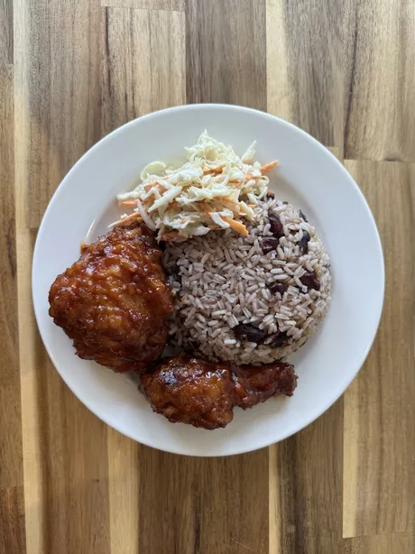 A student special plate: BBQ fried chicken with rice and peas and coleslaw