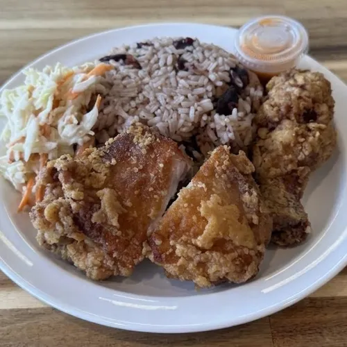 Crispy Caribbean-style fried chicken with rice and peas, coleslaw and hot sauce