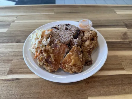 Crispy Caribbean-style fried chicken with rice and peas, coleslaw and hot sauce