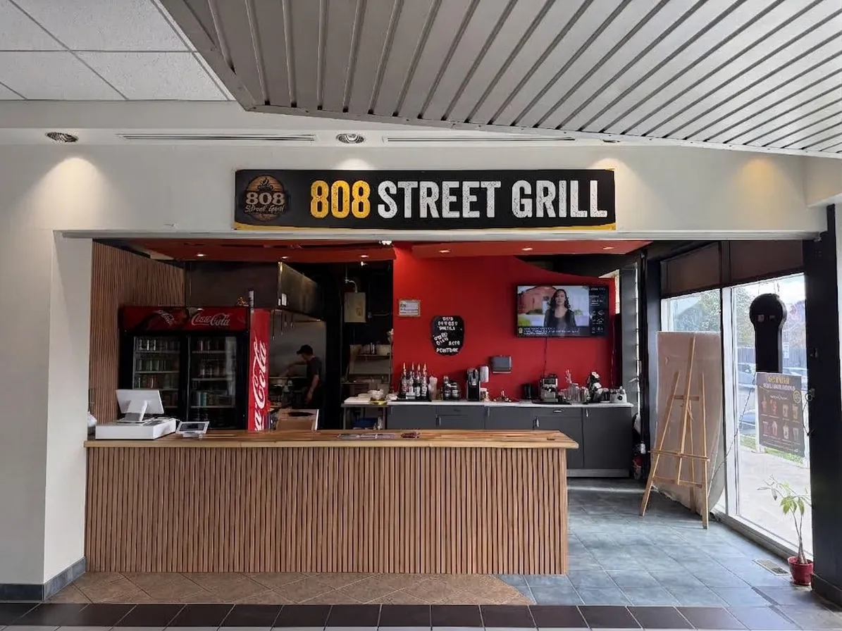 The 808 Street Grill counter and sign, with the kitchen open behind it, at Fincham & 16th in Markham