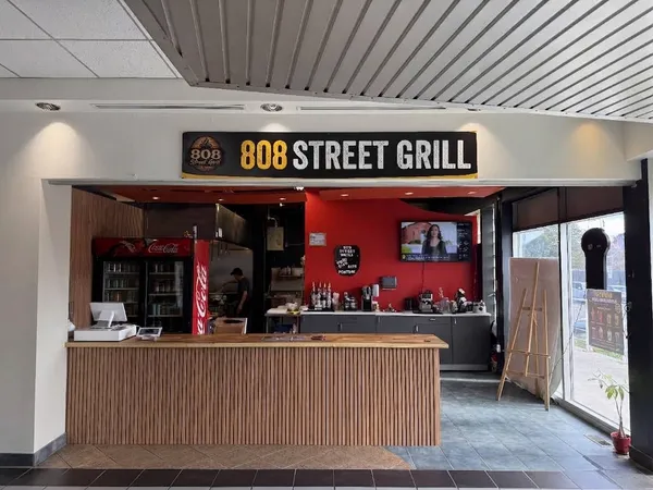 The 808 Street Grill counter and sign, with the kitchen open behind it, at Fincham & 16th in Markham